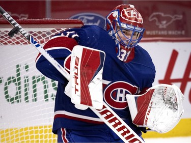 Canadiens goaltender Carey Price (31) makes a blocker save during NHL action against the Vancouver Canucks in Montreal on Saturday, March 20, 2021.