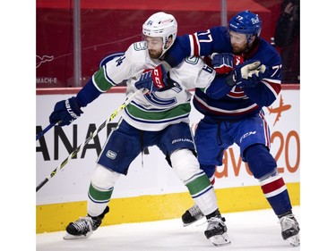 Canadiens defenceman Brett Kulak (77) holds Vancouver Canucks centre Tyler Motte (64) back during NHL action in Montreal on Saturday, March 20, 2021. A moment later a penalty was called on the play allowing the Canucks to score.