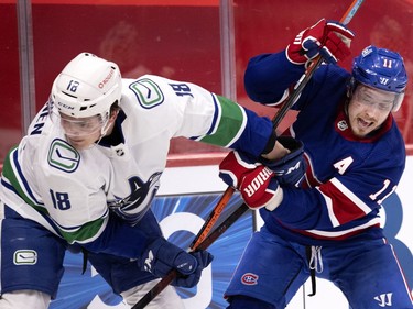 Canadiens' Brendan Gallagher (11) tries to shake off Vancouver Canucks right wing Jake Virtanen (18) during NHL action in Montreal on Saturday, March 20, 2021.