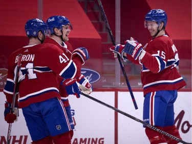 Montreal Canadiens centre Jesperi Kotkaniemi, right, (15) celebrates opening the scoring against the Edmonton Oilers with Montreal Canadiens left wing Paul Byron (41) and Montreal Canadiens left wing Artturi Lehkonen (62) during NHL action in Montreal on Tuesday, March 30, 2021.