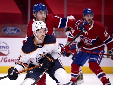 Montreal Canadiens centre Nick Suzuki (14) ties up Edmonton Oilers right wing Josh Archibald (15) during NHL action in Montreal on Tuesday, March 30, 2021.   (Allen McInnis / MONTREAL GAZETTE) ORG XMIT: 65951