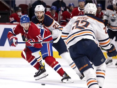 Montreal Canadiens centre Jesperi Kotkaniemi (15) carries the puck over the blue line under pressure from Edmonton Oilers defensemen Darnell Nurse (25) and Tyson Barrie (22) during NHL action in Montreal on Tuesday, March 30, 2021.