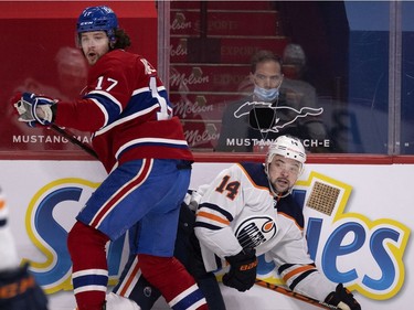 Montreal Canadiens right wing Josh Anderson (17) dumps Edmonton Oilers centre Devin Shore (14) during NHL action in Montreal on Tuesday, March 30, 2021.