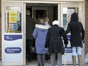 People arrive for their appointments to get vaccinated against COVID-19 at the vaccination clinic at the Bob Bernie Arena in the Pointe Claire suburb of Montreal Friday March 5, 2021. (John Mahoney / MONTREAL GAZETTE) ORG XMIT: 65841 - 7053