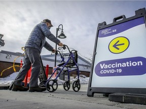MONTREAL, QUE.: MARCH 5, 2021 -- A man pushes his walker as he arrives for his appointment to get vaccinated against COVID-19 at the vaccination clinic at the Bob Bernie Arena in the Pointe Claire suburb of Montreal Friday March 5, 2021. (John Mahoney / MONTREAL GAZETTE) ORG XMIT: 65841 - 8858