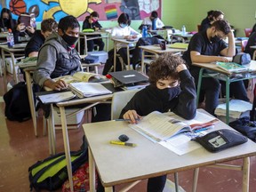 John F. Kennedy High School students read at their desks during class last November. The school will close until March 29 after a student and staff member tested positive for what is probably the B.1.1.7 COVID variant.