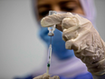 An Egyptian medical worker administers a dose of the Oxford-AstraZeneca COVID-19 vaccine on March 4, 2021, in Cairo on the first day of vaccination in Egypt.