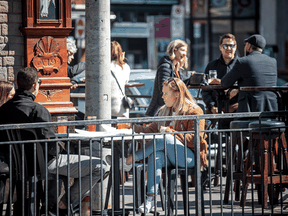 People sit at a restaurant patio to take advantage of sunny weather in Ottawa, March 20, 2021.