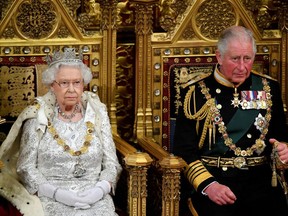 Britain's Queen Elizabeth II sits with Prince Charles, Prince of Wales, on the Sovereign's throne ahead of delivering the Queen's Speech at the State Opening of Parliament in the Houses of Parliament in London on Oct. 14, 2019.