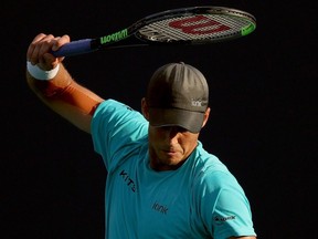 Vasek Pospisil winds up to smash his racquet while playing Mackenzie McDonald during the Miami Open at Hard Rock Stadium in Miami Gardens, Fla., Wednesday, March 24, 2021.