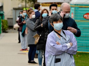 Health-care workers wait in line to receive the Pfizer-BioNTech COVID-19 vaccine at a clinic in Vancouver on March 4, 2021.