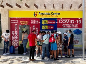 Tourists and locals wait in front of a Covid-19 testing center in Playa del Carmen, Mexico, on March 2, 2021.