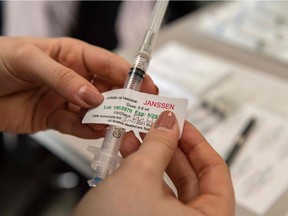 Pharmacist resident Lauren Toscano labels syringes with the Johnson & Johnson COVID-19 vaccine in Boston.