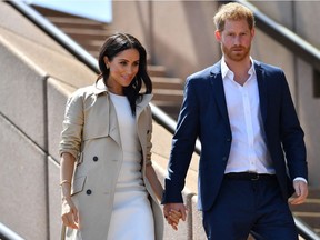 (FILES) In this file photo taken on October 16, 2018 Britain's Prince Harry and his wife Meghan walk down the stairs of Sydneys iconic Opera House to meet people in Sydney. - After a week of digs at Britain's royal family, just how far will Prince Harry and Meghan Markle go in their hotly anticipated interview with Oprah Winfrey? Millions of people will tune in to CBS the evening of March 7, 2021 to find out, and if that trickle of excerpts is any indication, they have scores to settle with Buckingham Palace a bit over a year after giving up frontline duties as royals and moving to southern California.