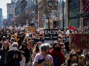 People march in downtown Montreal during a demonstration against anti-Asian racism on March 21, 2021