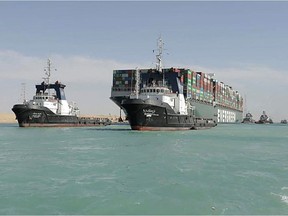A picture released by Egypt's Suez Canal Authority on March 29, 2021, shows a tugboat pulling the Panama-flagged MV 'Ever Given' container ship after it was fully dislodged from the banks of the Suez.
