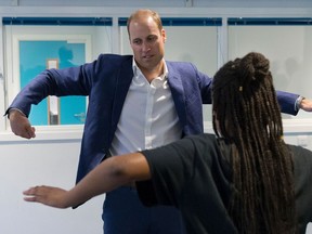 Britain's Prince William, Duke of Cambridge, learns a dance move with Scariofunk dance collective during a visit to Caius House Youth Centre in London on September 14, 2016.