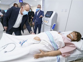 Quebec Health Minister Christian Dubé checks out a mannequin connected to an Air1 ventilator at the CAE plant in Montreal on Friday.