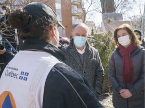 Quebec Health Minister Christian Dubé and Bourassa-Sauvé MNA Paule Robitaille talk to a community worker helping with vaccination efforts for people in need in Montreal North, on Monday, March 29, 2021.