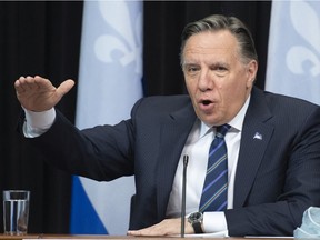 Quebec Premier François Legault gestures as he speaks of the third wave, during a news conference on the COVID-19 pandemic, Tuesday, March 30, 2021 at the legislature in Quebec City.