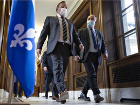 Quebec Premier François Legault and Quebec Health Minister Christian Dubé walk to a news conference on the COVID-19 pandemic, Wednesday, March 31, 2021 at the legislature in Quebec City.