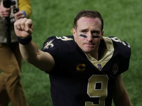 New Orleans Saints quarterback Drew Brees (9) waves to the crowd as he walks off the field after an NFC Divisional Round playoff game against the Tampa Bay Buccaneers at Mercedes-Benz Superdome on Jan. 17, 2021, in New Orleans.