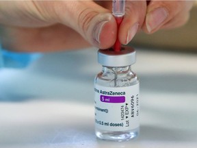 A medical worker prepares a dose of AstraZeneca's COVID-19 vaccine amid a vaccination campaign in Ronquieres, Belgium March 15, 2021. REUTERS/Yves Herman