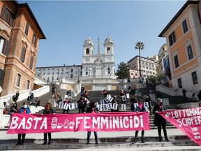 Feminist activists demonstrate at the Spanish Steps for the elimination of violence against women and to demand more government aid for those struggling financially due to the coronavirus disease (COVID-19) crisis, in Rome, Italy February 26, 2021. REUTERS/Yara Nardi