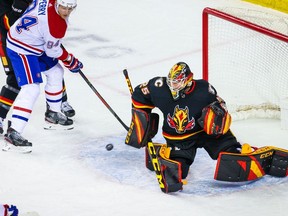 Mar 11, 2021; Calgary, Alberta, CAN; Calgary Flames goaltender Jacob Markstrom (25) makes a save as Montreal Canadiens right wing Corey Perry (94) tries to score during the first period at Scotiabank Saddledome. Mandatory Credit: Sergei Belski-USA TODAY Sports