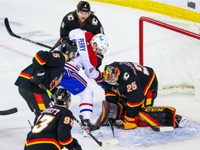 Calgary Flames goaltender Jacob Markstrom (25) makes a save as Montreal Canadiens right wing Corey Perry (94) tries to score during the third period at Scotiabank Saddledome March 11, 2021.