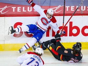 Montreal Canadiens right-winger Brendan Gallagher and Calgary Flames defenceman Christopher Tanev collide during the first period at the Scotiabank Saddledome in Calgary on March 11, 2021.