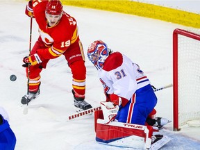 Canadiens goaltender Carey Price makes a save as Flames' Matthew Tkachuk tries to score during the second period at Scotiabank Saddledome in Calgary on Saturday, March 13, 2021.