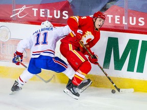 The Canadiens’ Brendan Gallagher tries to check the Flames’ Matthew Tkachuk during game Saturday night in Calgary.