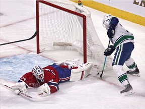 Canadiens goaltender Jake Allen stretches to make a toe save against Canucks' Brandon Sutter during first-period action at the Bell Centre Friday night.