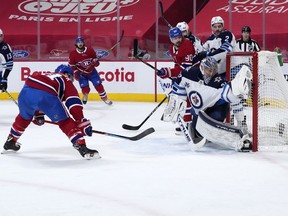 Brendan Gallagher scores his second goal against Winnipeg Jets goalie Connor Hellebuyck in second-period action at the Bell Centre on Saturday night.