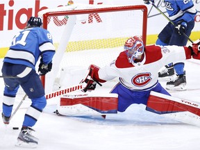 Canadiens goalie Carey Price stretches to make save against the Jets Kyle Connor during game Wednesday night in Winnipeg.