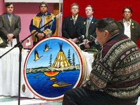 Elder William Ratt performs a traditional drum song during a ceremony commemorating the signing of the agreement concerning a new relationship between Hydro-Quebec and the Crees of Eeyou Istchee in Chissassibi, Que. Monday, April 19, 2004.