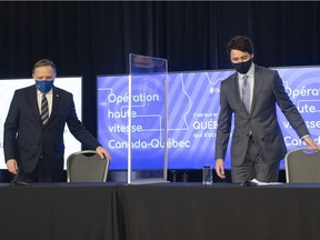 Prime Minister Justin Trudeau, right, and Quebec Premier Francois Legault walk in to announce high speed internet for Quebec regions, Monday, March 22, 2021 in Trois-Rivieres Que.