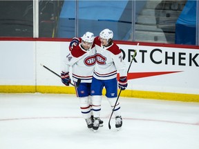 Montreal Canadiens forward Tyler Toffoli is congratulated by forward Nick Suzuki (14) on his goal against the Winnipeg Jets during the second period at Bell MTS Place March 15, 2021.