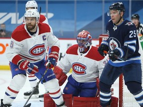 Montreal Canadiens goaltender Carey Price  tracks the puck along with defenceman Shea Weber, left, and Winnipeg Jets centre Paul Stastny in Winnipeg on Feb. 25, 2021.