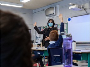 The EMSB showed off their newly installed air purifiers at Pierre Elliott Trudeau elementary school in Montreal on Monday January 11, 2021. The HEPA filter hangs from the wall in the background while principal Tanya Alvarez takes over a class at the elementary school.