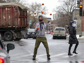 Gabriel Boileau juggles for spare change at the corner of Atwater Ave. and St-Antoine St. in late February.