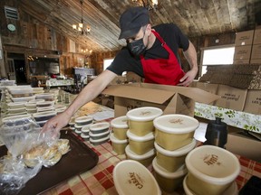 Simon Bernard puts together a meal-in-a-box at his La P'tite Cabane d'la Côte sugar shack in Mirabel, north of Montreal on Feb. 23, 2021.
