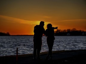 A couple take a sunset walk along the waterfront in the Lachine borough of Montreal Sunday March 15, 2020. "We need to continue to take care of our physical, emotional and mental well-being; nature has so many of those solutions," Fariha Naqvi-Mohamed writes.