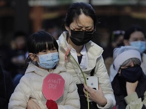 People attend a vigil in Montreal Sunday, March 21, 2021 to commemorate the victims of the March 16 murders of eight people, primarily Asian women in the Atlanta area. "In Montreal, police estimate that racial acts against Asians have increased five-fold in the past year," Erik Martinez Kuhonta and Kimberley Ens Manning write.