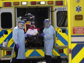 Urgences-sante paramedics transfer a Covid-19 suspect patient to the ER at Notre-Dame Hospital in Montreal, on Tuesday, March 23, 2021.