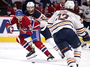 Montreal Canadiens centre Jesperi Kotkaniemi carries the puck over the blue line under pressure from Edmonton Oilers defencemen Darnell Nurse (25) and Tyson Barrie in Montreal on March 30, 2021.