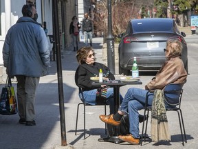 Annie Tremblay, left, and good friend Martine Simard pulled out at table and a couple chairs, to have a brunch on Duluth St. on Sunday April 4, 2021.