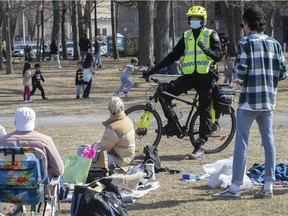 Montreal police officers took to their bikes on Sunday April 4, 2021 to remind people at Lafontaine park to keep a proper social distance during the COVID-19 pandemic.