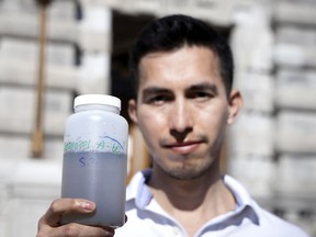 Fernando Sanchez-Quete, a research assistant at McGill University, with sewer water that is tested for COVID-19.